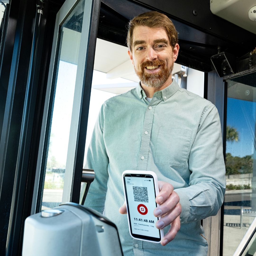 Customer boarding the bus and scanning their pass