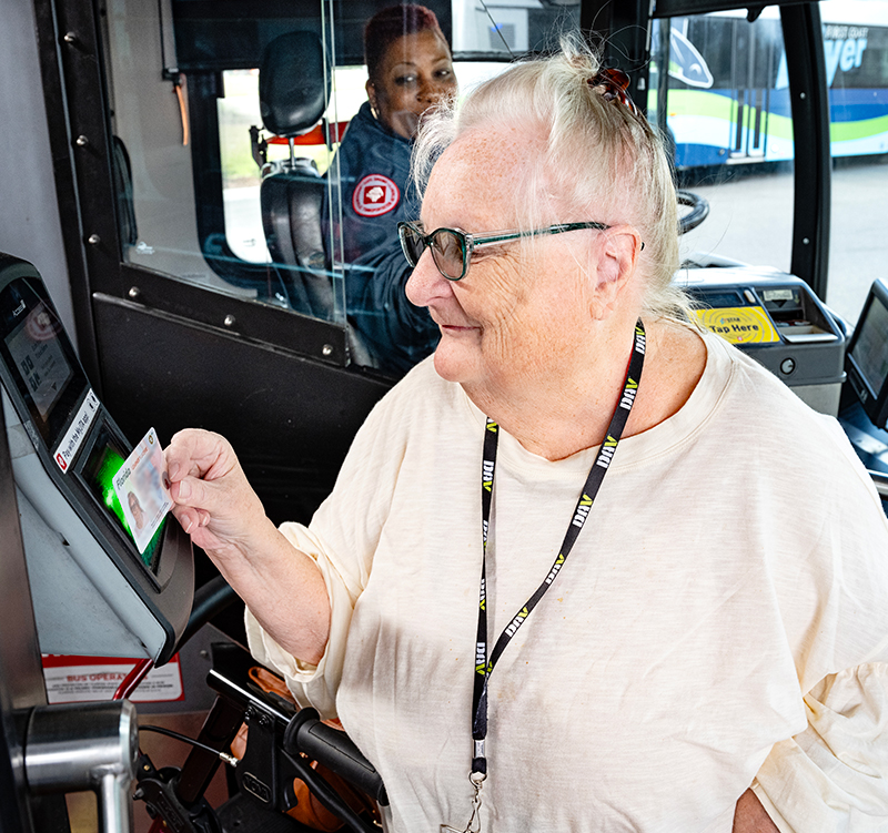 Senior Scanning ID On The Bus